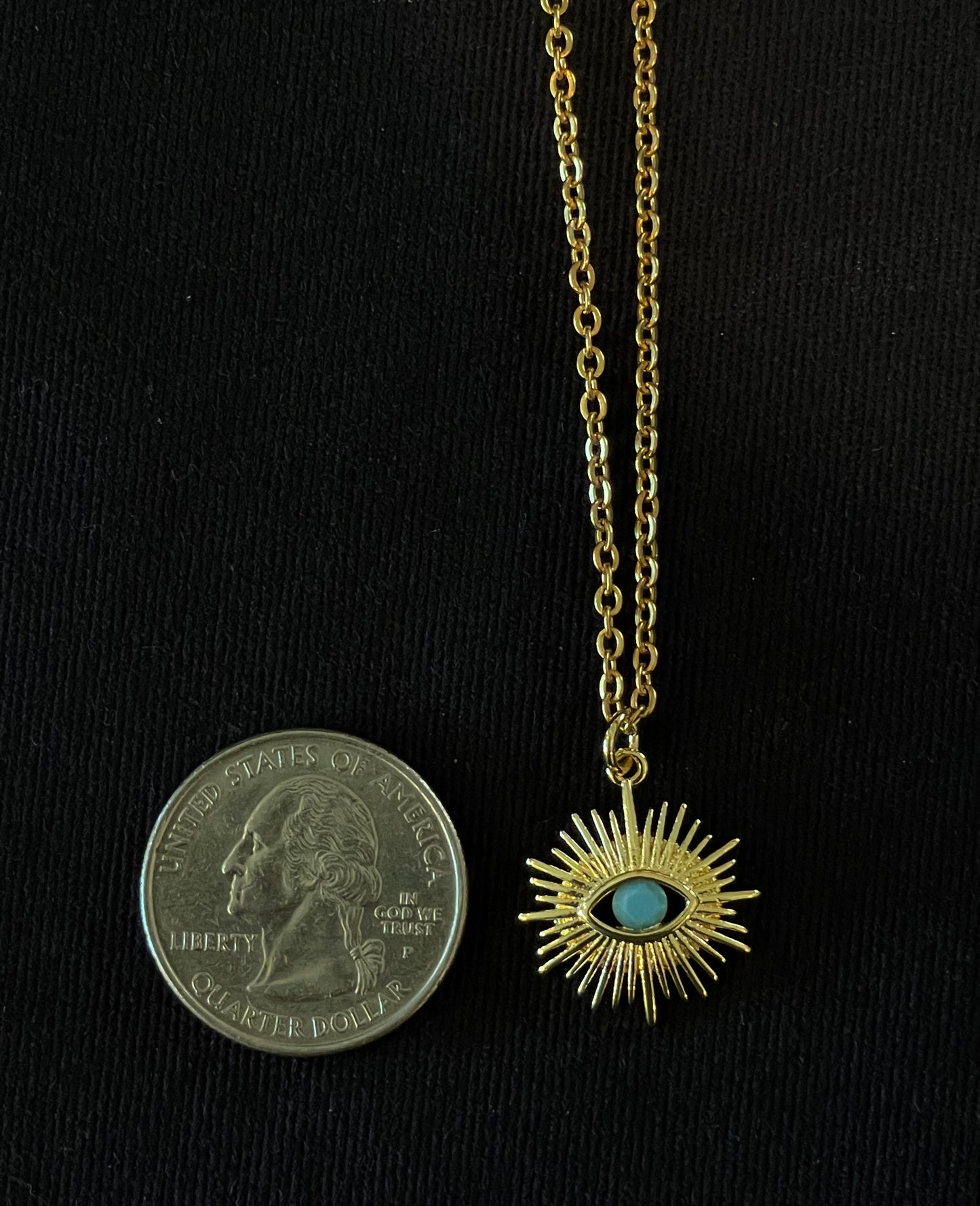 Gold starburst evil eye pendant with turquoise stone on chain